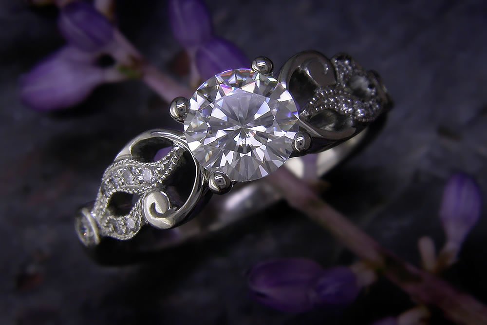 Silver ring with central stone and side details