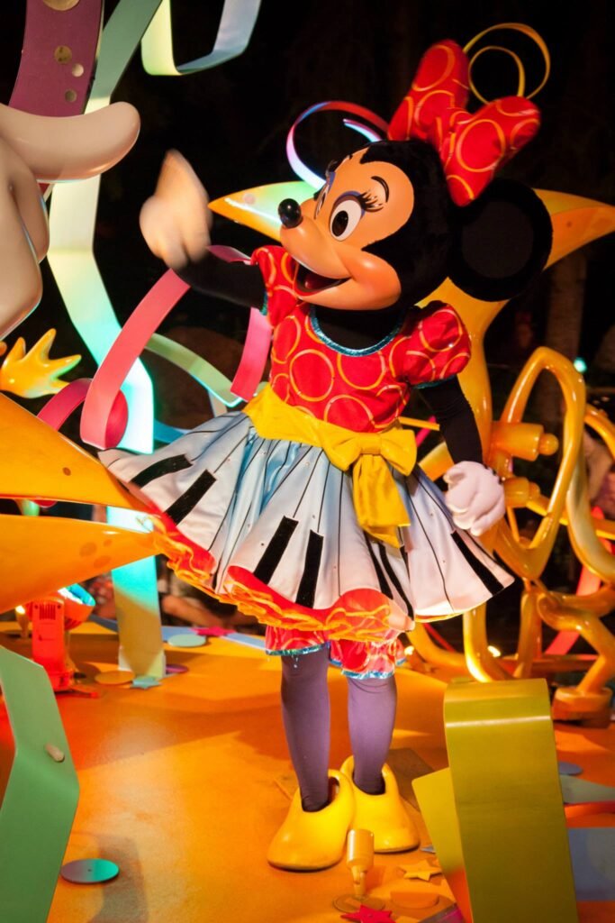 Minnie Mouse in a Whiz Bees costume at a Disney parade.
