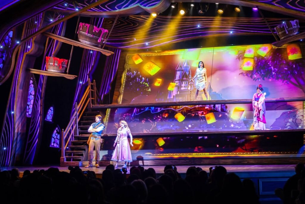 Performers on a brightly lit stage during a nighttime show at the Festival of the Lanterns on Main Street at Magic Kingdom at Walt Disney World