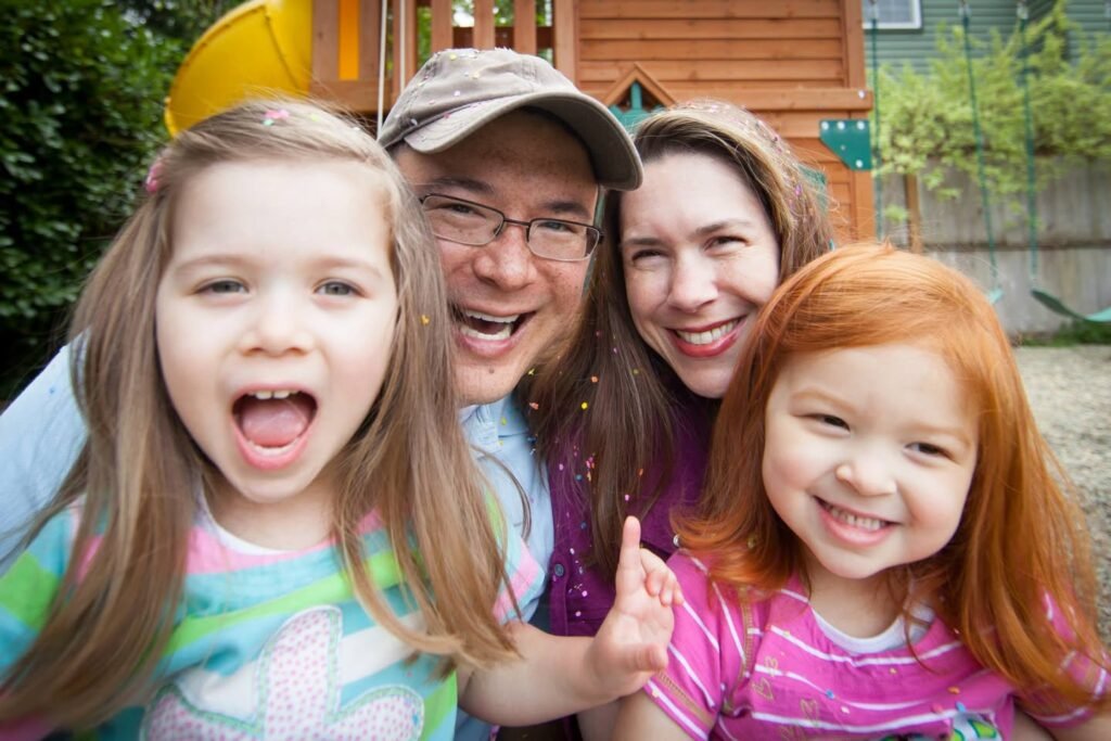 A group of smiling individuals enjoying time together outdoors.