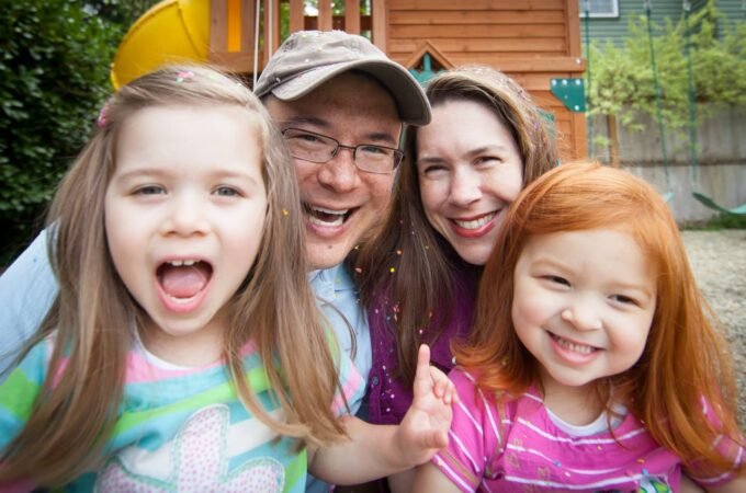 A group of smiling individuals enjoying time together outdoors.