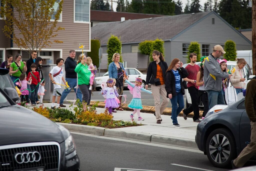 A group of people parades on a downtown street.