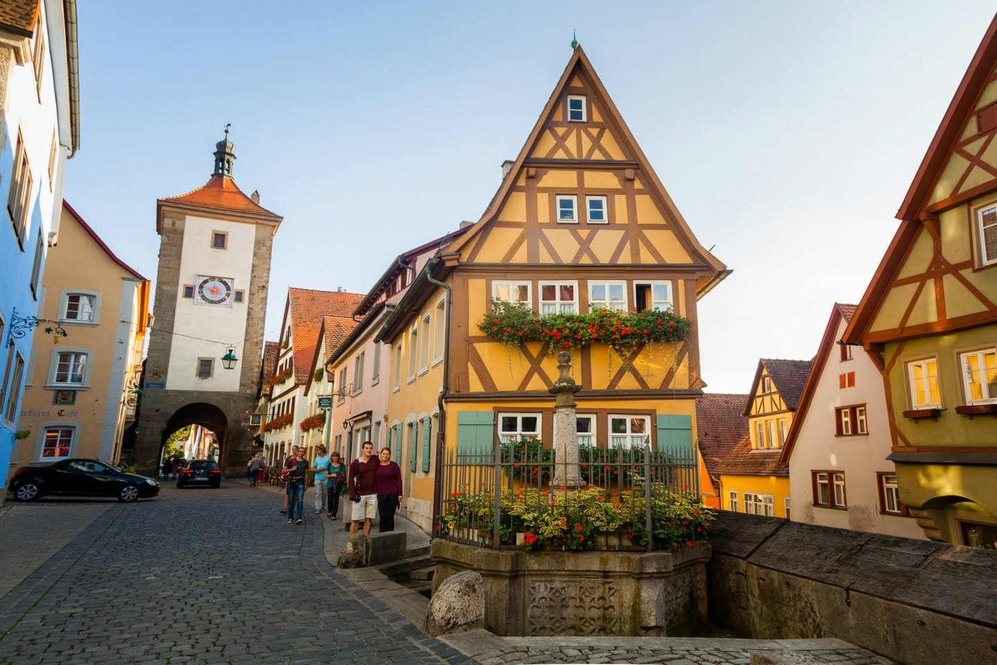 Rothenburg ob der Tauber A picturesque European town featuring traditional half-timbered houses with steep roofs and a historic clock tower in the background.
