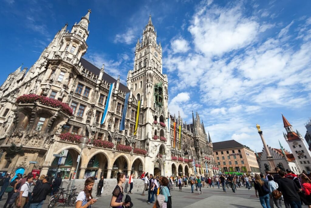The ornate Gothic architecture of Vienna's City Hall stands under a bright blue sky.