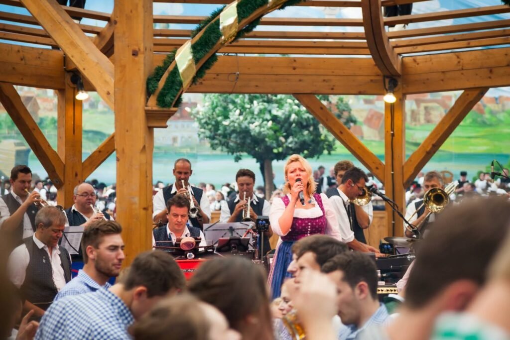 A live band plays under a wooden pergola during an outdoor wedding, followed by close-ups of the rustic timber structure and greenery.