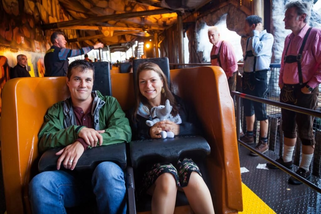 Adults and children ride in a comfortable tour vehicle, with uniformed guides nearby.