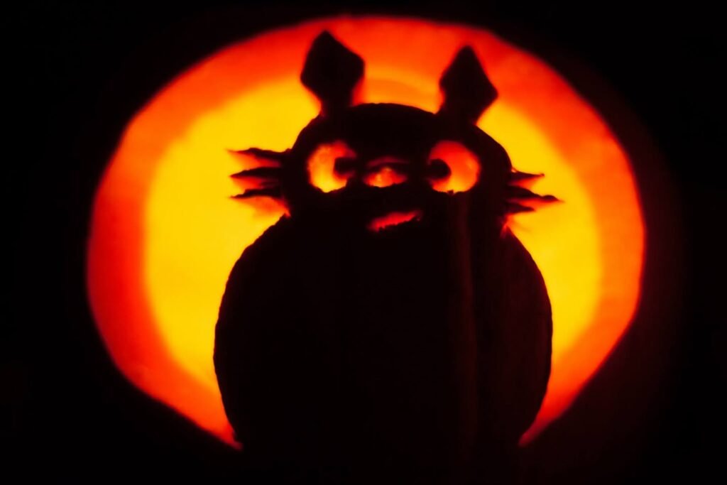 Dark owl silhouette decal placed on a glowing Jack-o'-lantern.