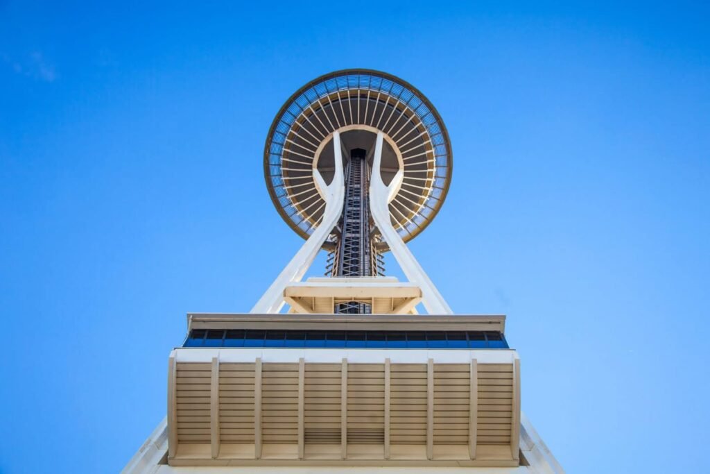 The top of the Vancouver's iconic tower is captured against a clear blue sky, showcasing its unique architectural design.