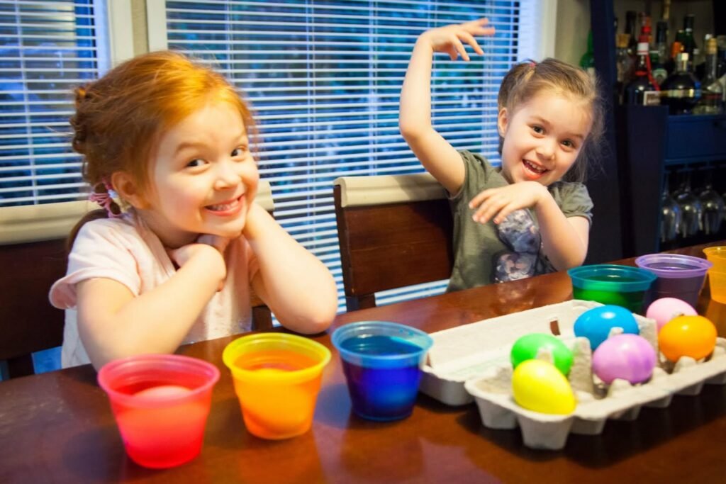 Childrenenjoying a fun bath with dye and colorful eggs.