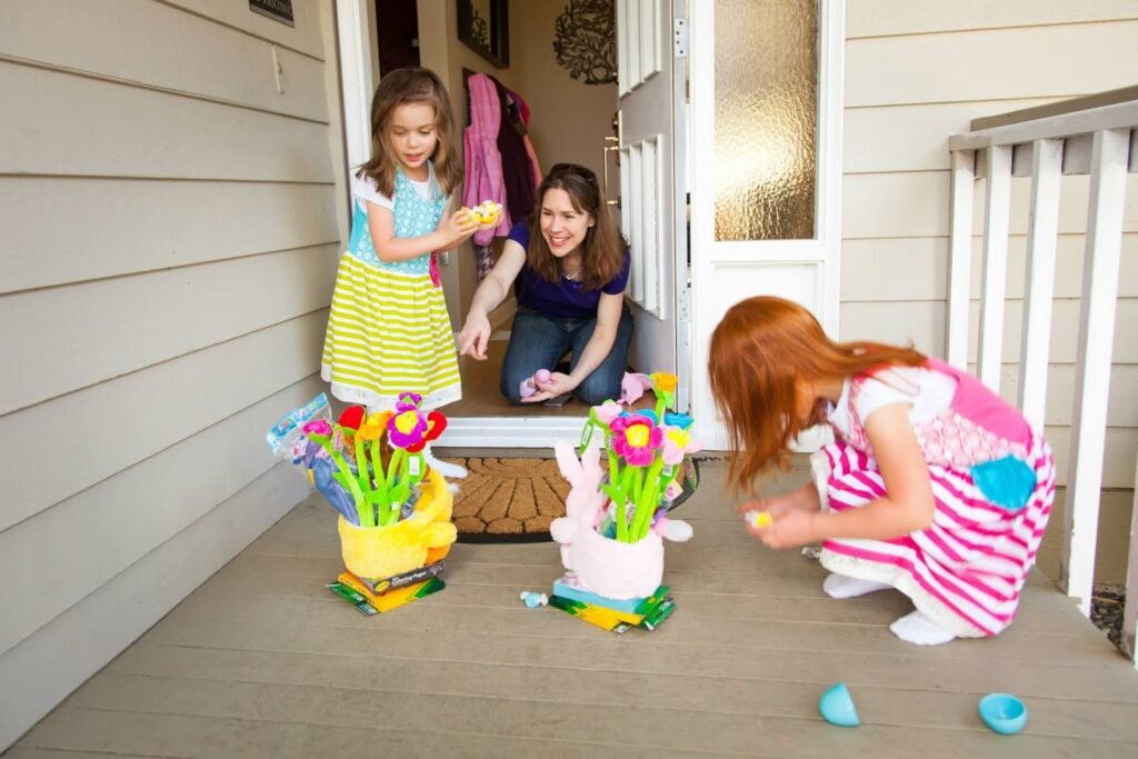 Children and an adult posing together outdoors, featuring colorful decor and Easter motifs.