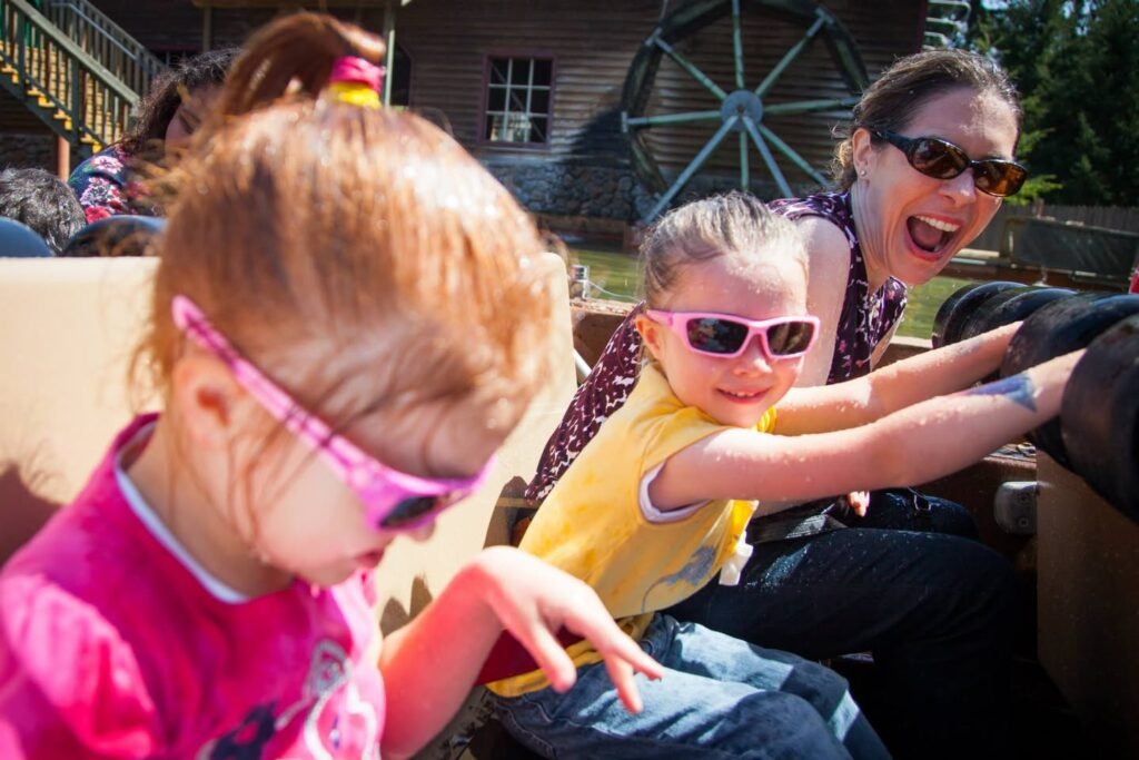 A family enjoys a ride on a buggy at an Amish farm, with the children wearing colorful sunglasses.
