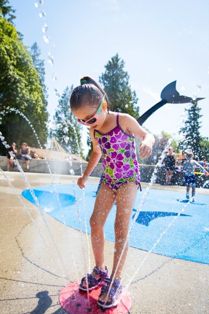 Playful splash in a public fountain on a sunny summer afternoon near Portland.