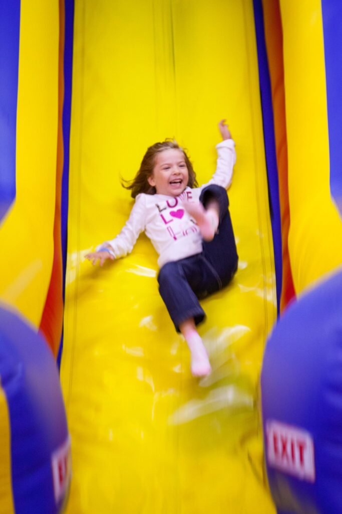 Having a blast sliding down our bright yellow and blue inflatable water slide.