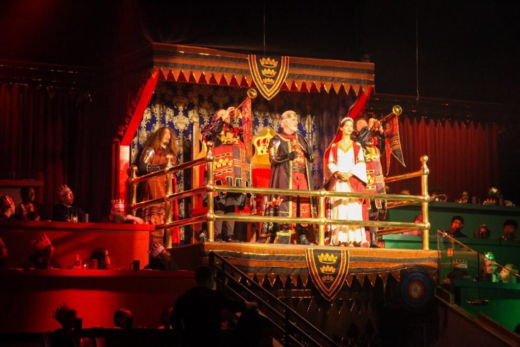 Cast members dressed in historical royal attire perform on a stage in the Paris casino at the Moulin Rouge, Paris, France.