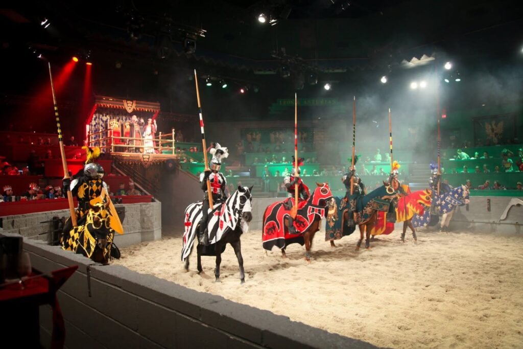 Knights on horseback lance during an indoor jousting tournament.