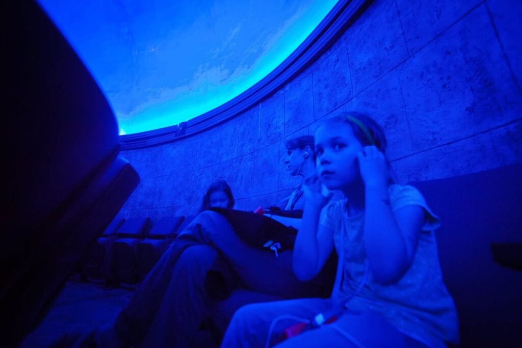 A person sitting in a dark room.