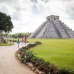 Staircase and vast lawn at Chichen Itza. Classic shots of El Castillo under a cloudy sky.