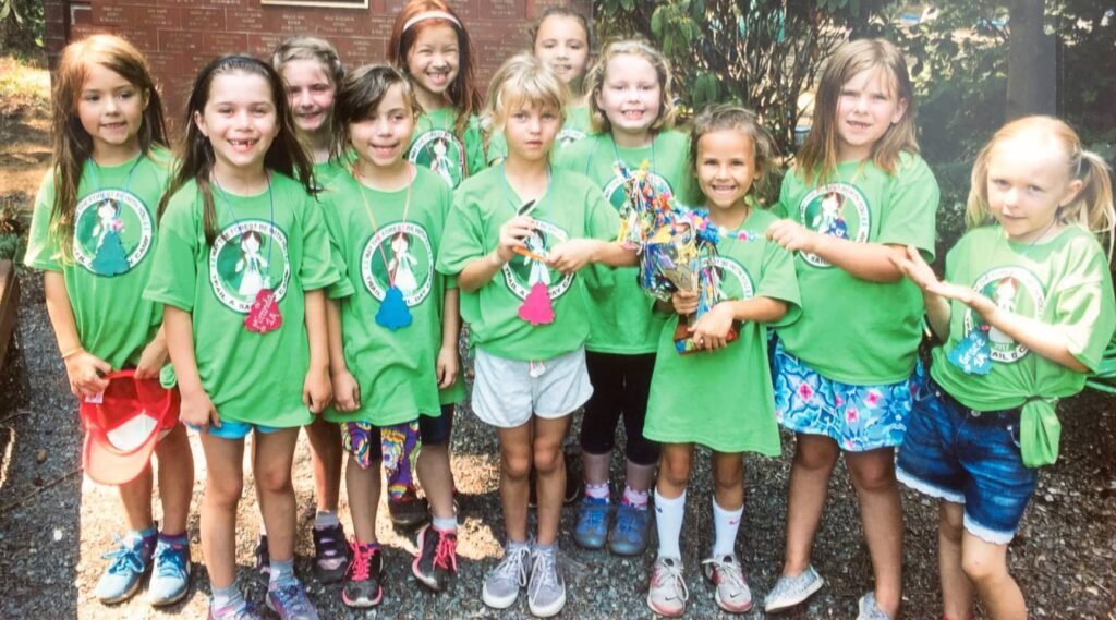 Children wearing green t-shirts with logo