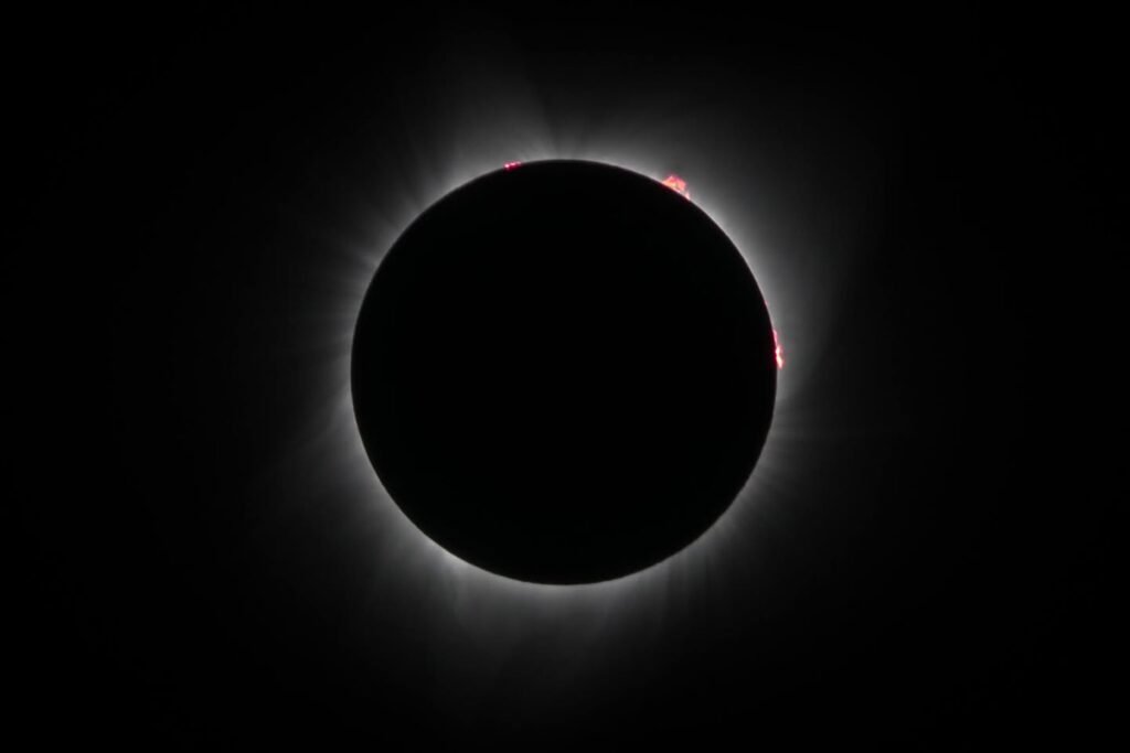 A series of photos capturing the total solar eclipse, showcasing the moon covering the sun and the corona's glow.