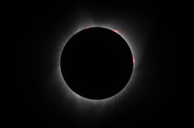A series of photos capturing the total solar eclipse, showcasing the moon covering the sun and the corona's glow.
