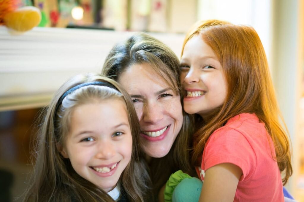 A joyful family portrait featuring three smiling individuals sharing a moment together.