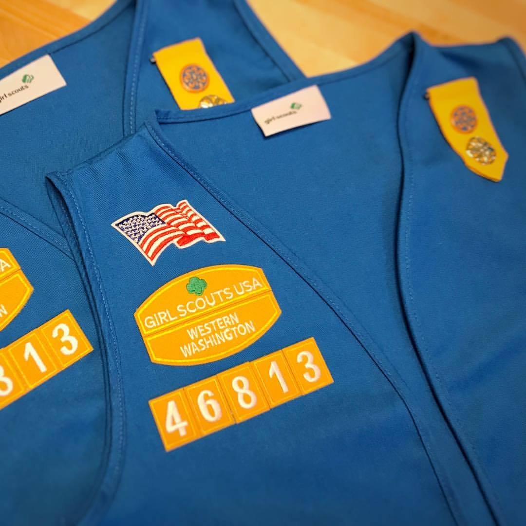 Daisies Blue Girl Scout vests featuring American flags and a Girl Scouts USA Western Washington patch. Troop number 46813 is displayed on a yellow patch.