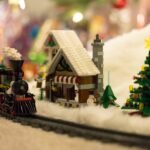 A charming LEGO Christmas train ride with a cozy snowy village and decorated trees.