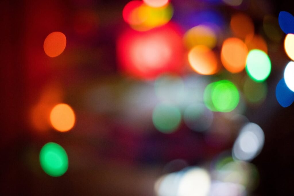 A mosaic of blurred, colorful bokeh lights.