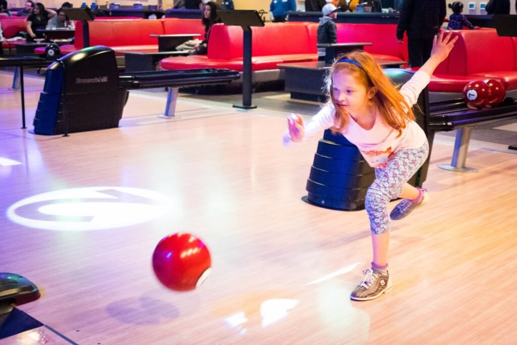 Child bowling at arcade lane