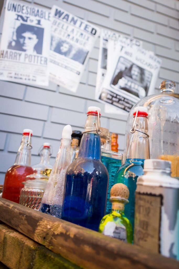 Colorful glass bottles filled with bubbly drinks on a wooden surface