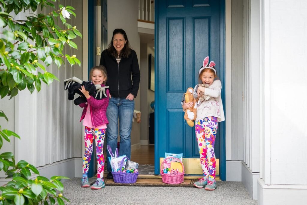 A family posing outside a home with a vibrant blue door and Easter baskets.