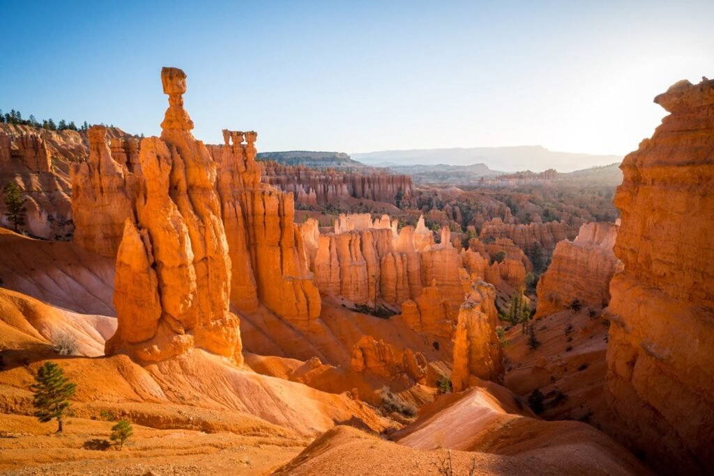 Vibrant red and orange rock formations under a clear blue sky.