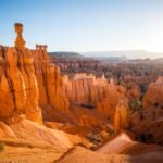 Vibrant red and orange rock formations under a clear blue sky.