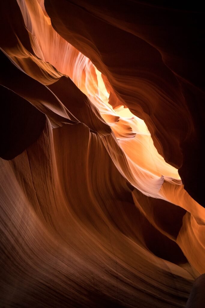 A swirling view of the illuminated orange sandstone walls in Antelope Canyon.