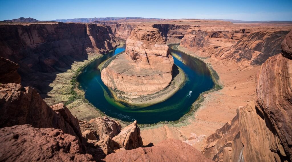 A panoramic view of Horseshoe Bend showing the river carving a dramatic curve through the desert canyon.