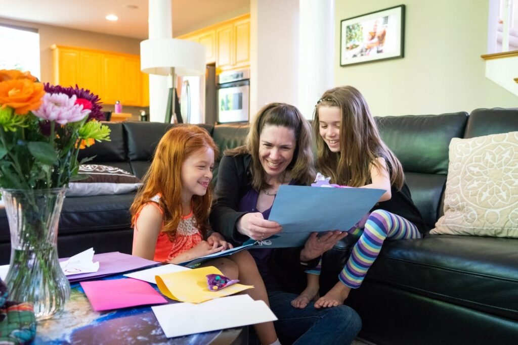 A family enjoys a creative activity together in a cozy living room, surrounded by vibrant flowers and warm lighting.