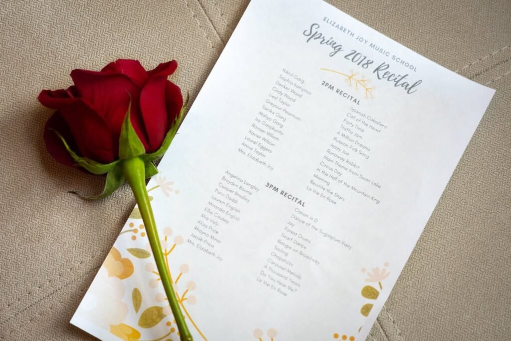 A close-up view of a Spring 2018 Bridal event seating chart featuring a classic red rose accent and floral botanical illustrations on white stationery.