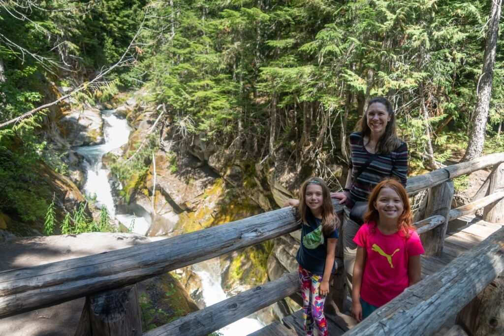 Enjoying a view of a scenic mountain waterfall surrounded by lush green forest.