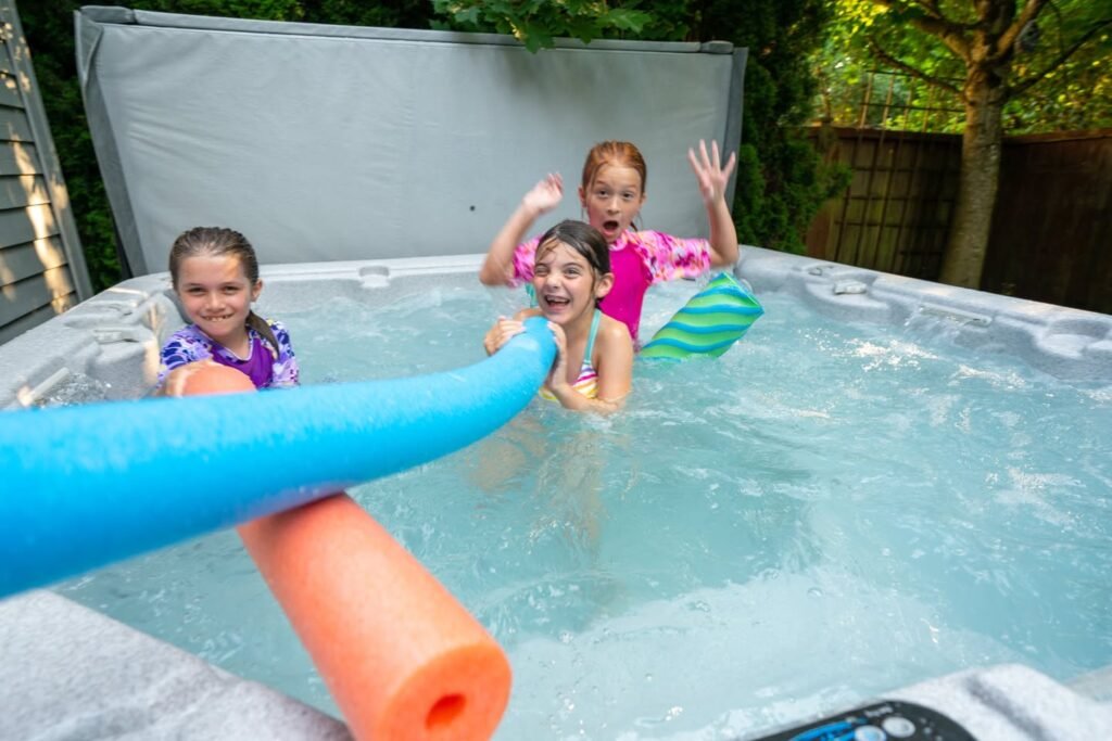 Children playing in an above-ground pool with pool noodles on a sunny summer day. Enjoying a cool swim with colorful pool toys.
