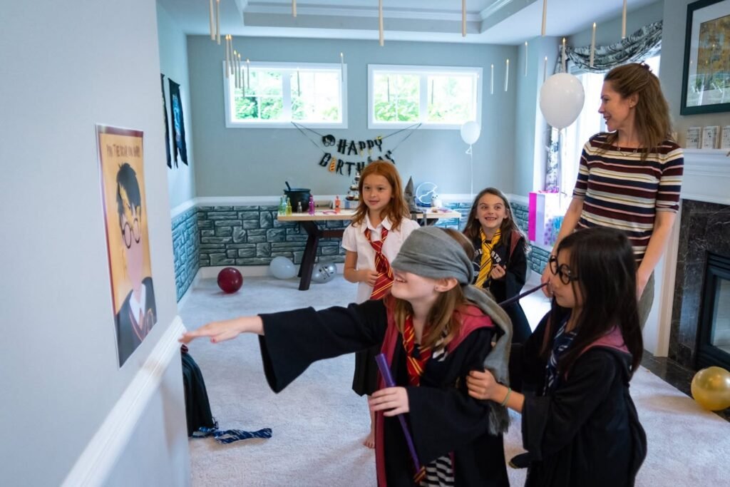 Children dressed in magical robes celebrating a birthday party.