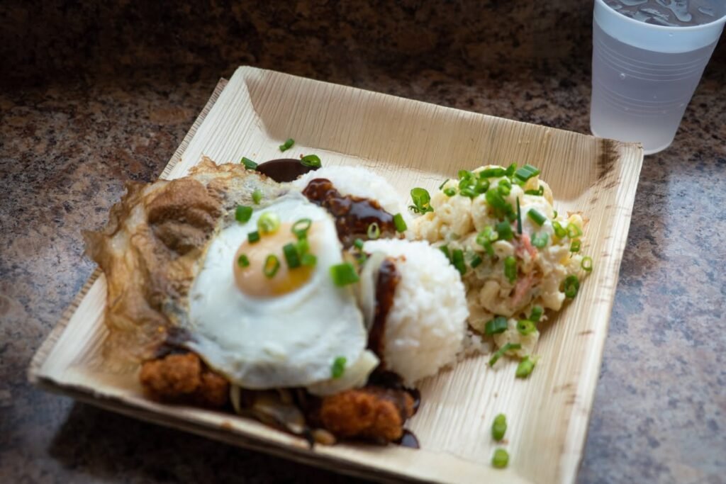 A plate with eggs, rice, and side dishes, garnished with green onions.