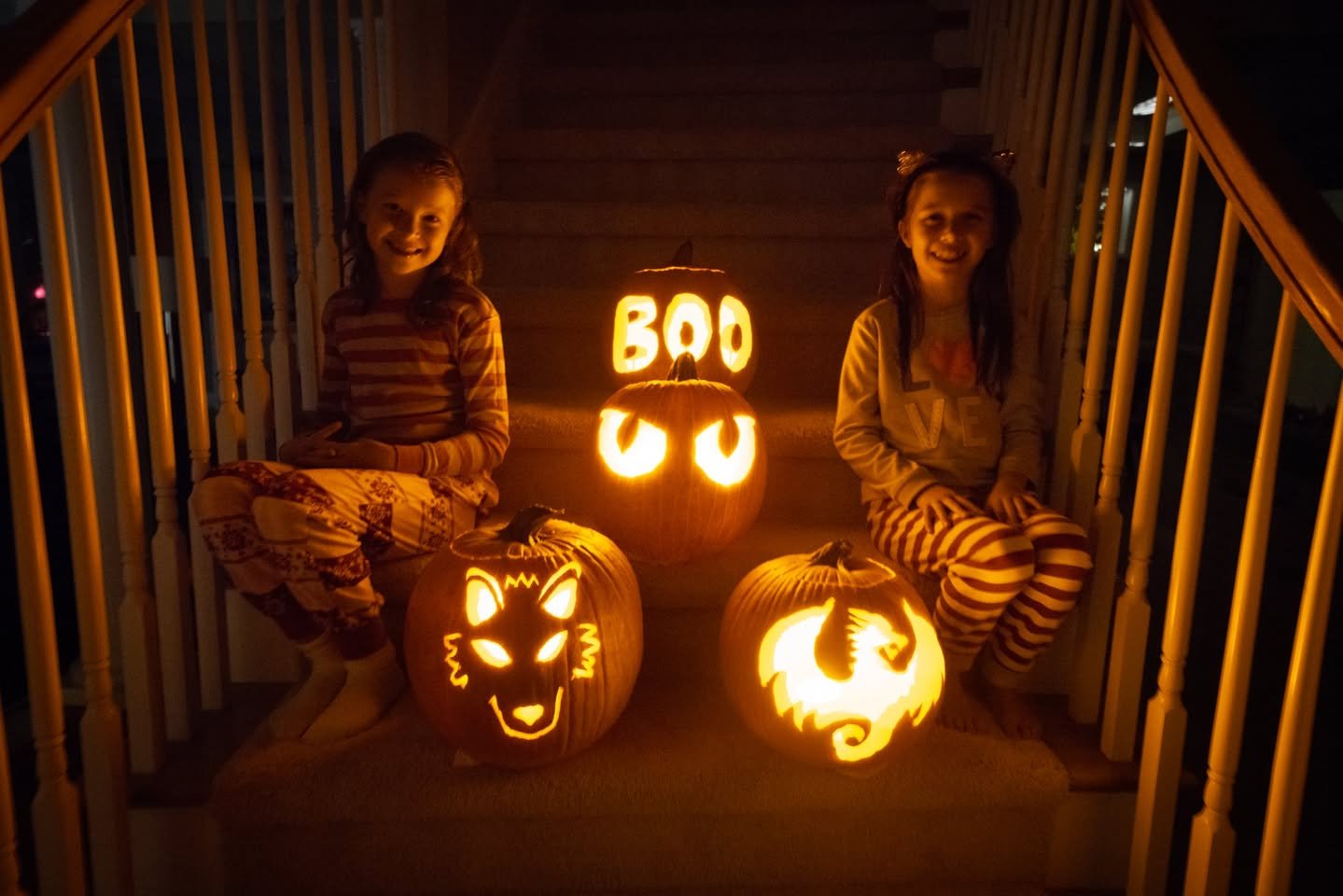 Jack-o’-Lanterns Spooky Halloweencared on a front porch.
