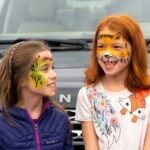 Two kids with colorful face paint