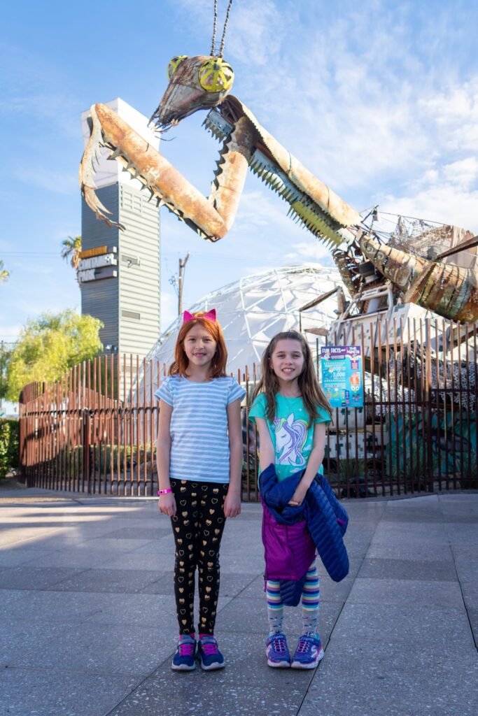 Children enjoy the Uptown PNW Green Giant Construction Museum in Seattle, Washington, with the iconic giant machine in the background.