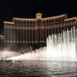 Container Park The famous Bellagio fountains dancing in front of the illuminated hotel at night.