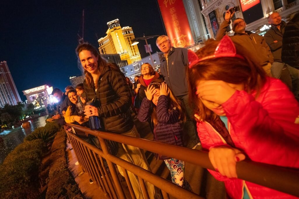 A group of people enjoying a bright and festive night out, with colorful lights illuminating the scene and a sense of celebration in the air.