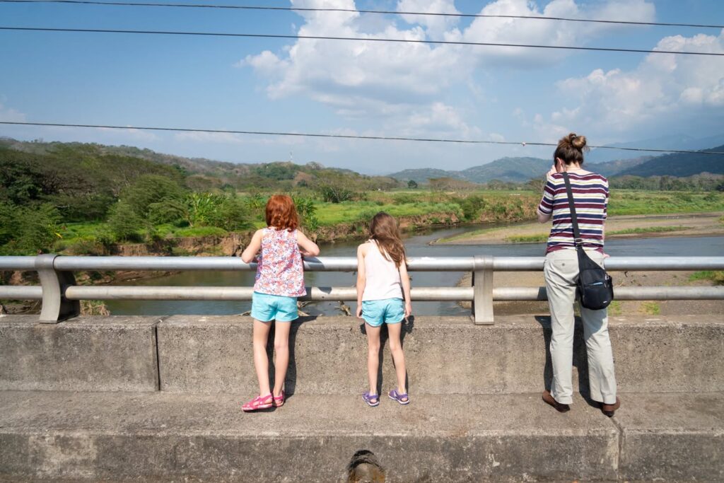 People enjoying the scenic view from a river bank.