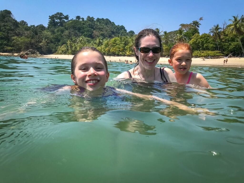 A family enjoys a swim in crystal-clear waters.