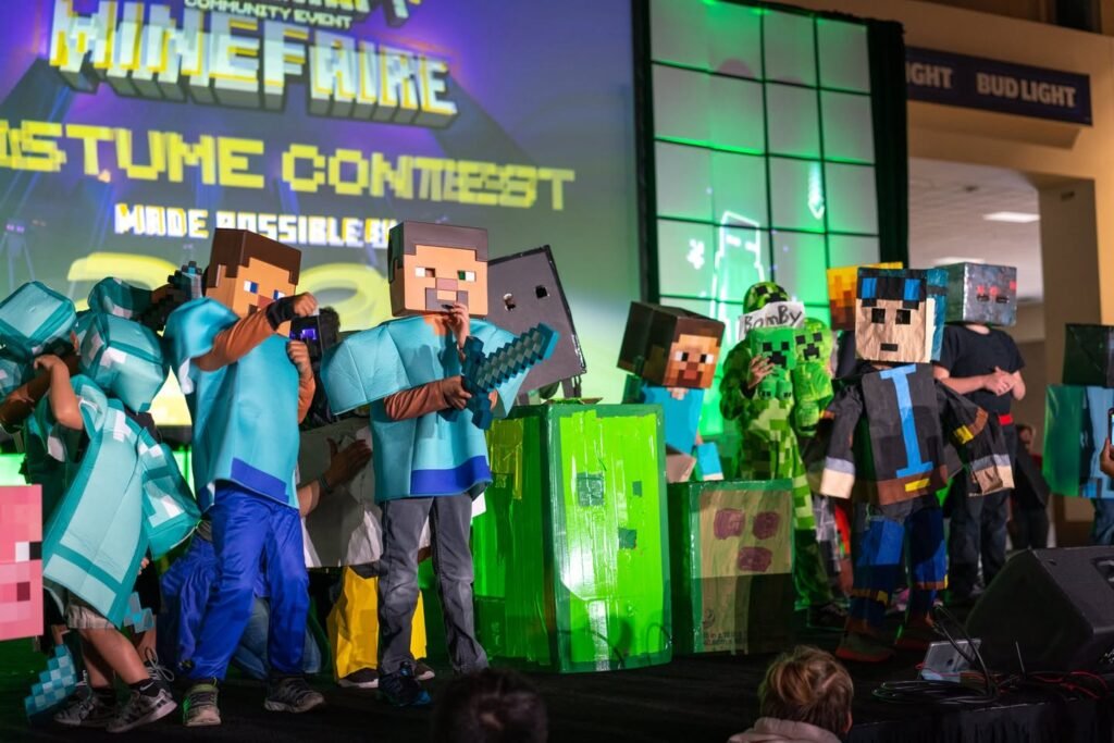 Participants in handmade Minecraft costumes on stage at a themed costume contest event.