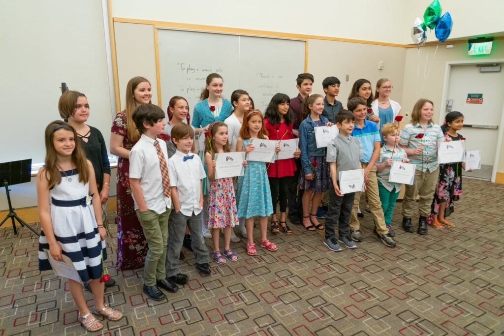 Students proudly receiving awards in a classroom setting, celebrating academic and personal accomplishments. A group photo capturing moments of recognition and support.